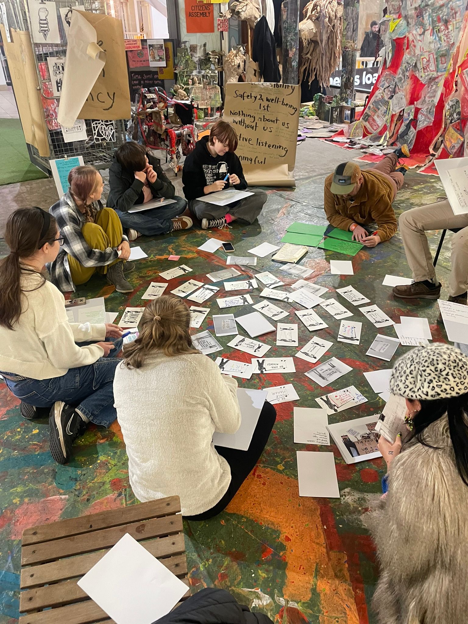 Young people working together with cards and creative materials during an England youth participation session