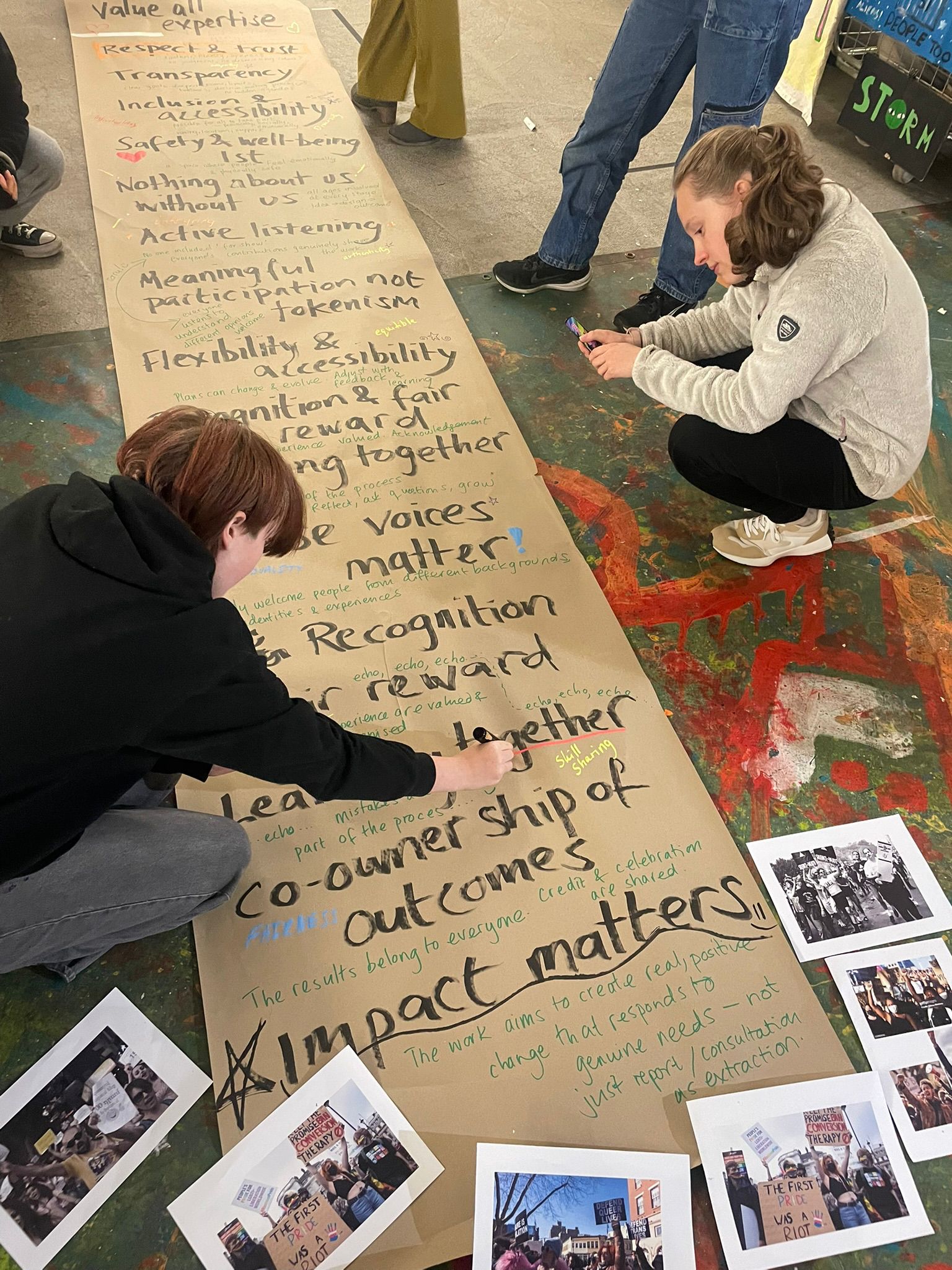 Young people annotating a large shared paper during an England youth participation session